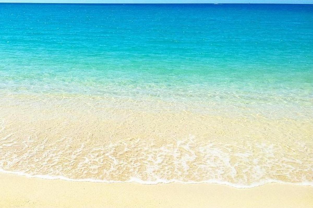 a beach with the ocean and the sand and water