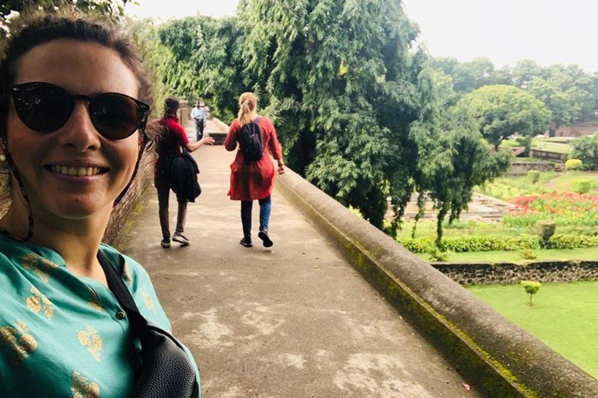 a woman standing on a path in a park