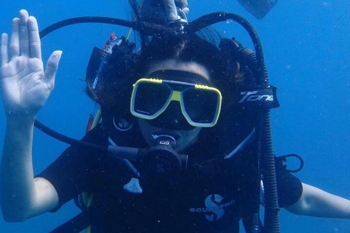 a woman in a diving suit and sunglasses