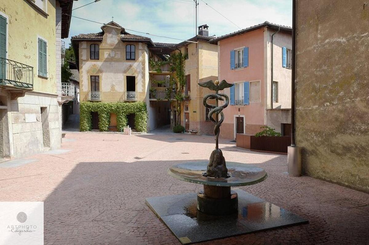 a fountain in the middle of a courtyard with buildings