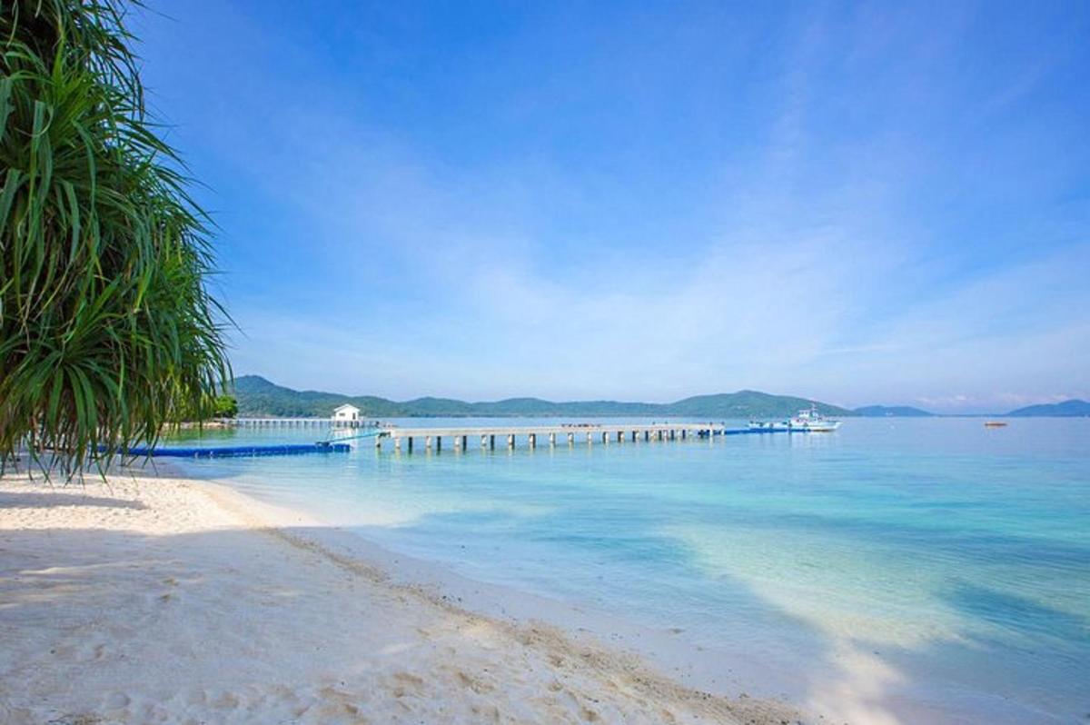 a beach with a pier in the water