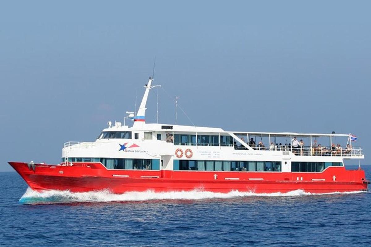 a red and white boat on the water