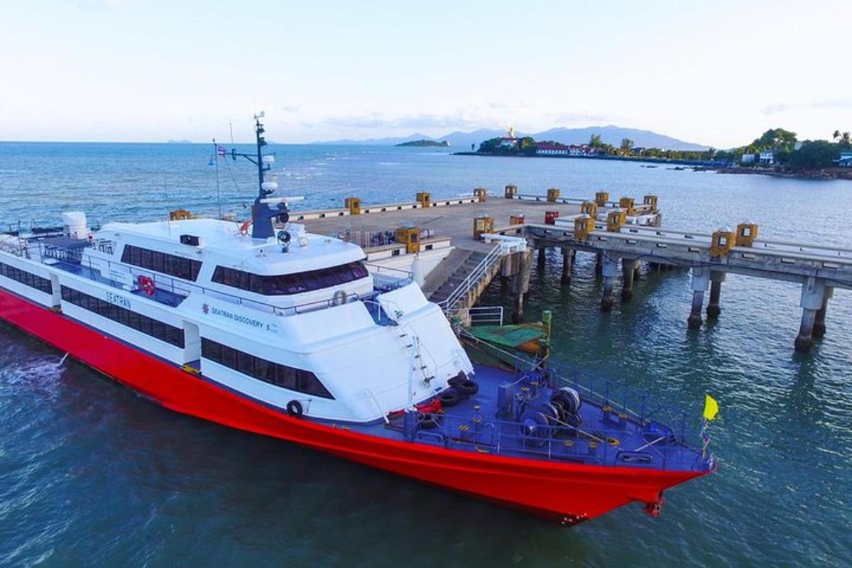 a red and white boat parked at a dock