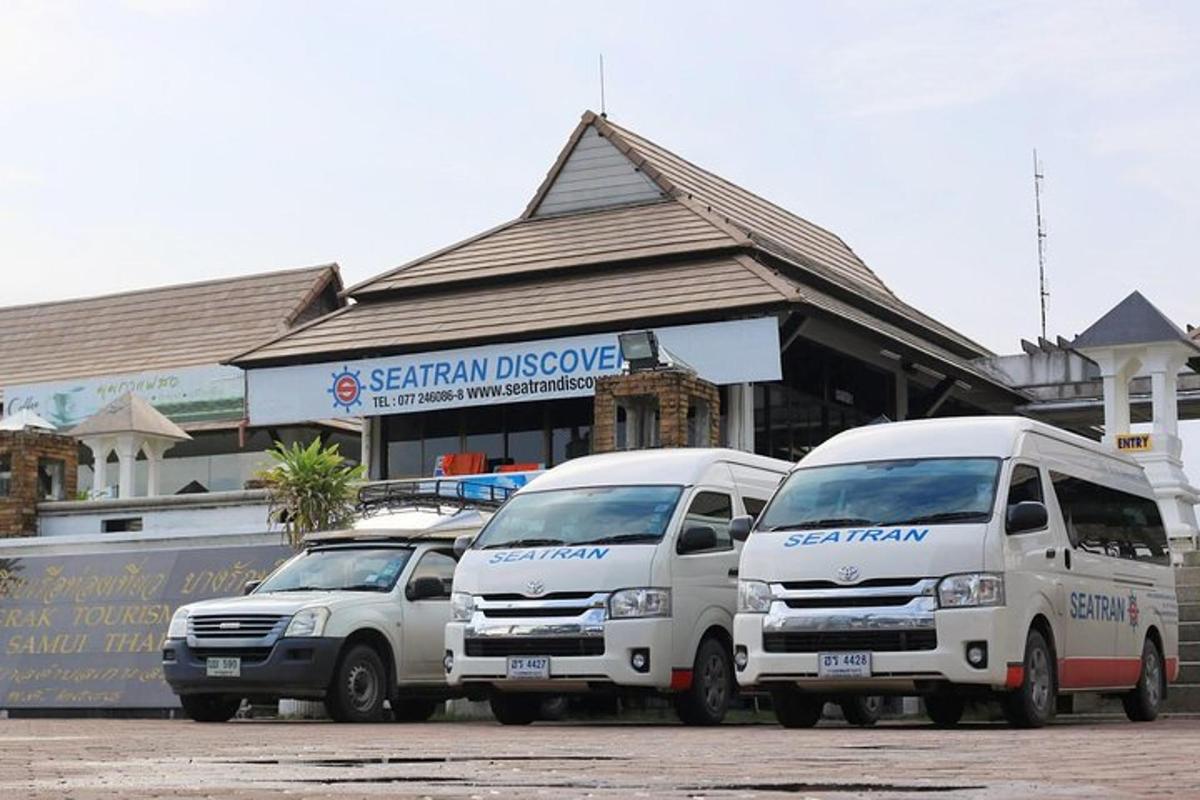 three trucks parked in a parking lot in front of a store