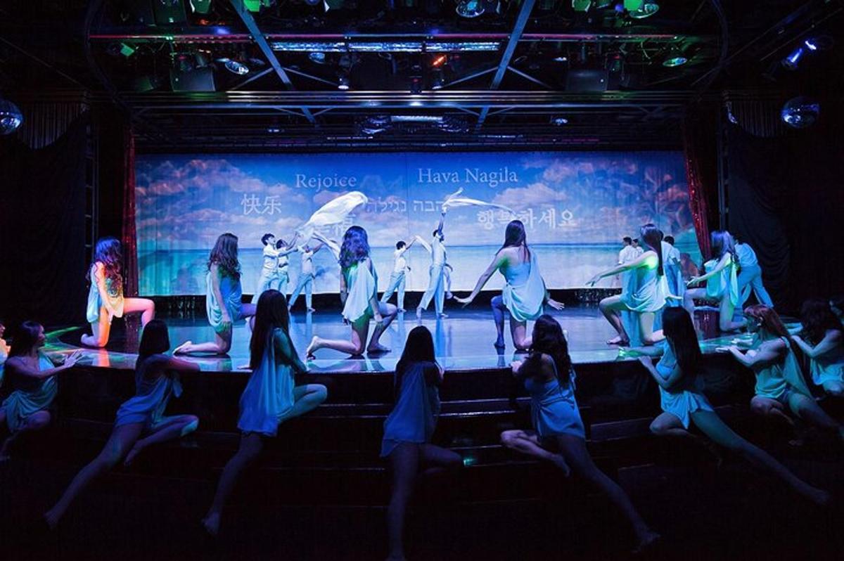 a group of women on a stage in front of a screen