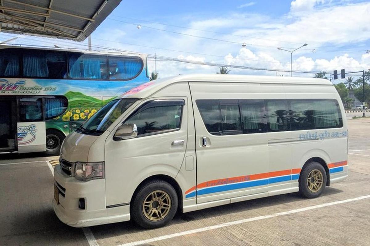 a white van is parked next to a bus