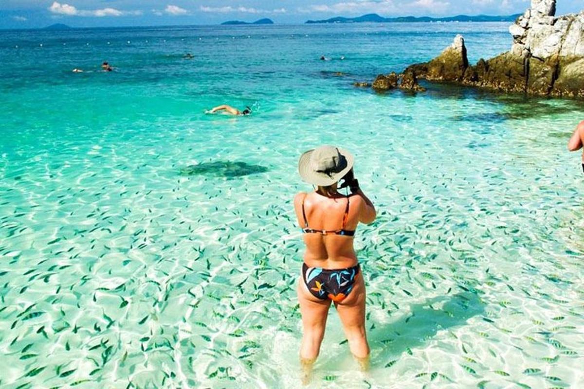 a woman standing in the water on a beach