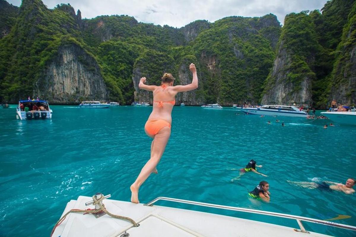 una donna che salta dal retro di una barca in acqua