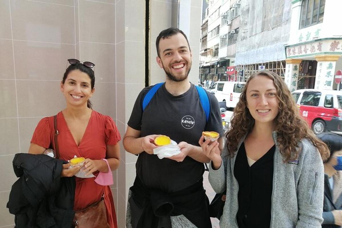 a man and two women holding food in their hands
