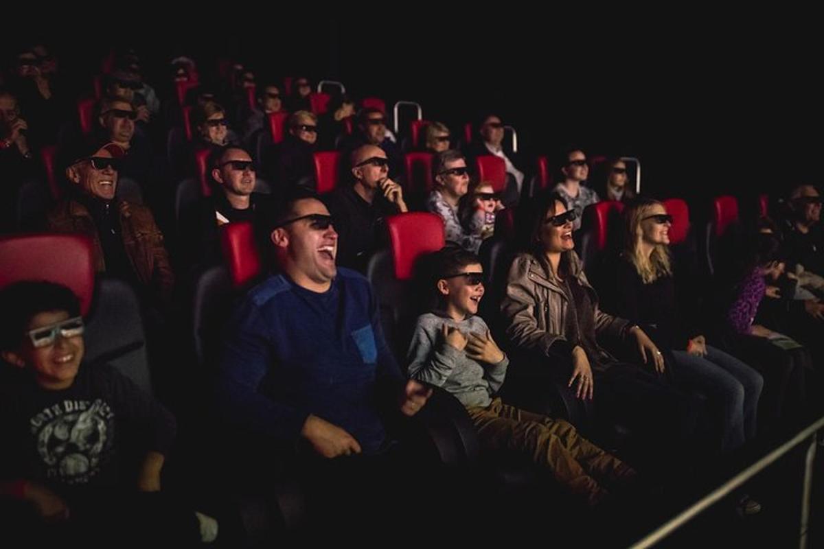 a group of people sitting in an audience in an auditorium