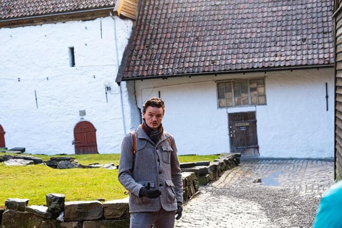 a man standing in front of a white building