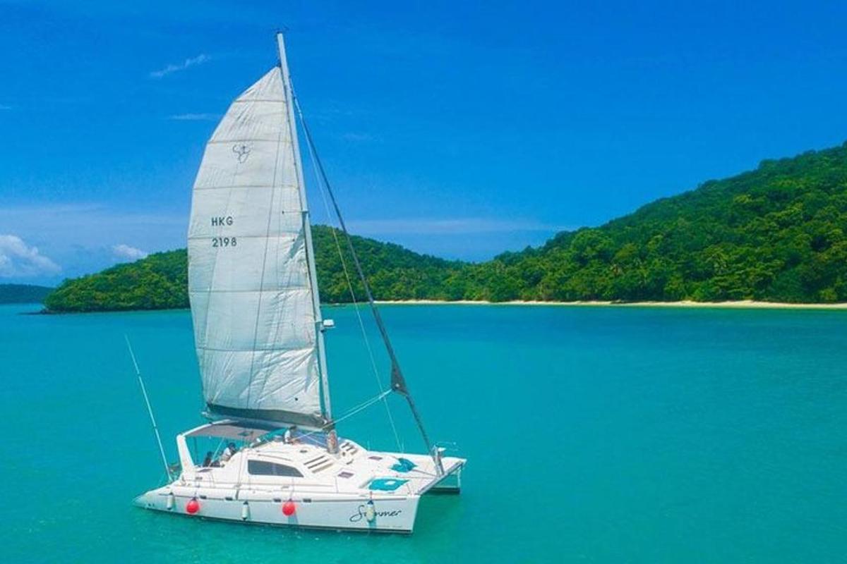 a white sail boat in the middle of the water