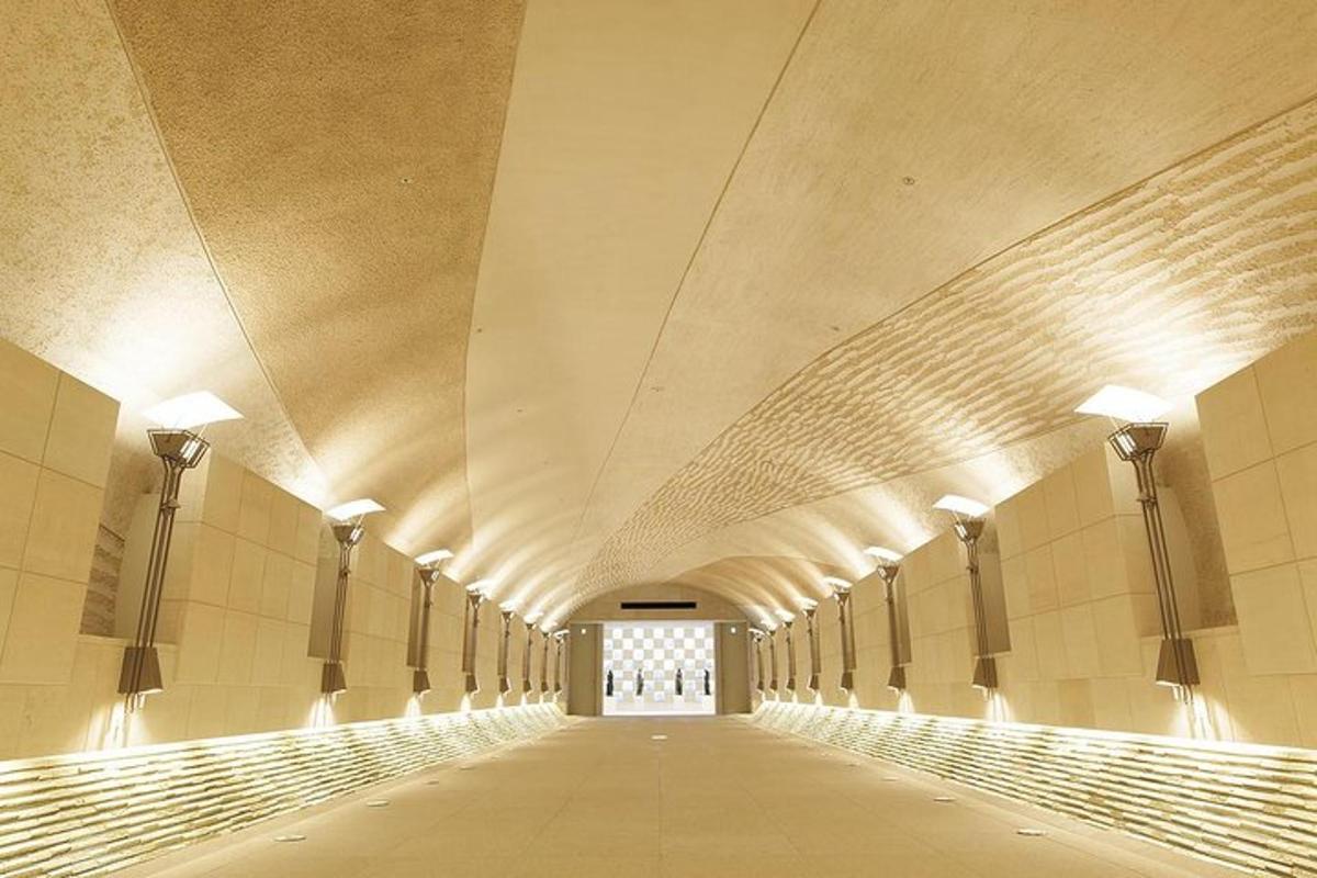 an empty hallway of a building with lights on the walls