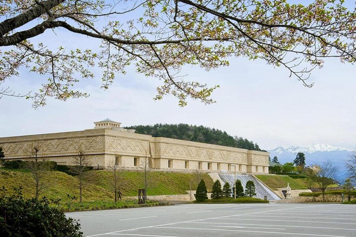 a large building on a hill with a parking lot