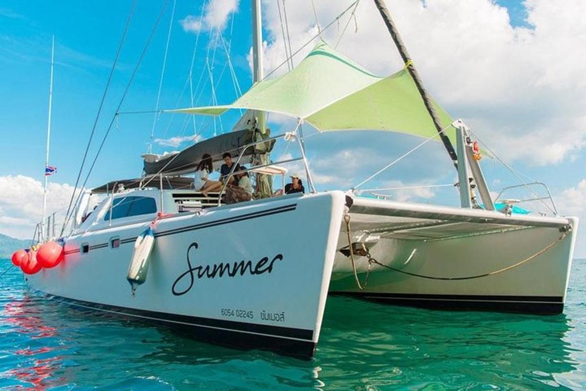 a sailboat in the water with people on it