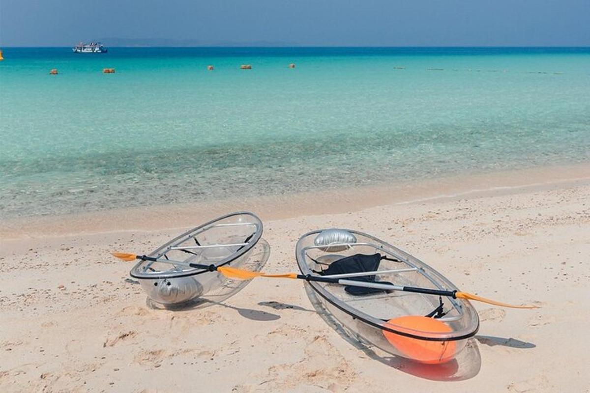 a boat on a beach with the ocean in the background