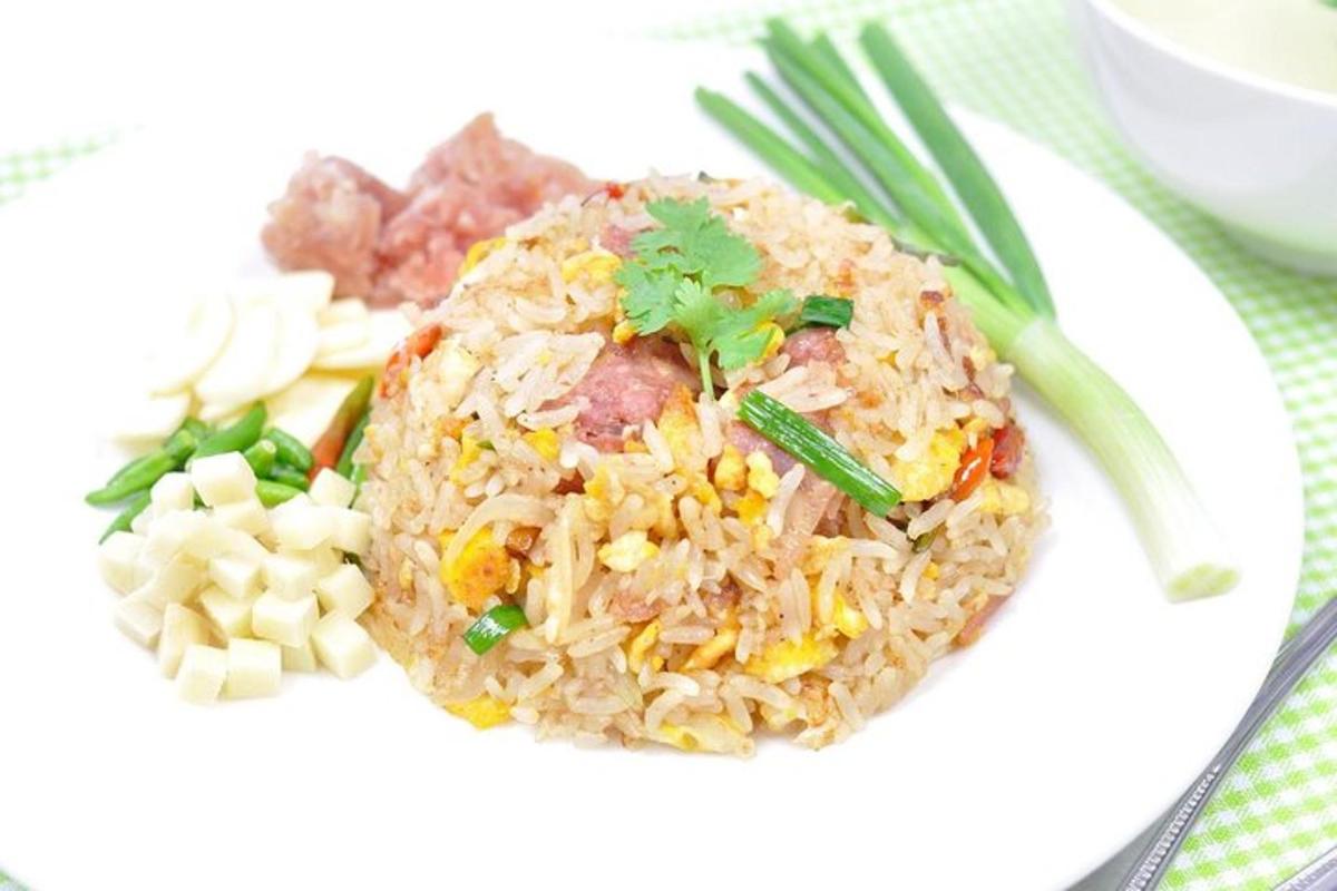 a white plate of food with rice and vegetables