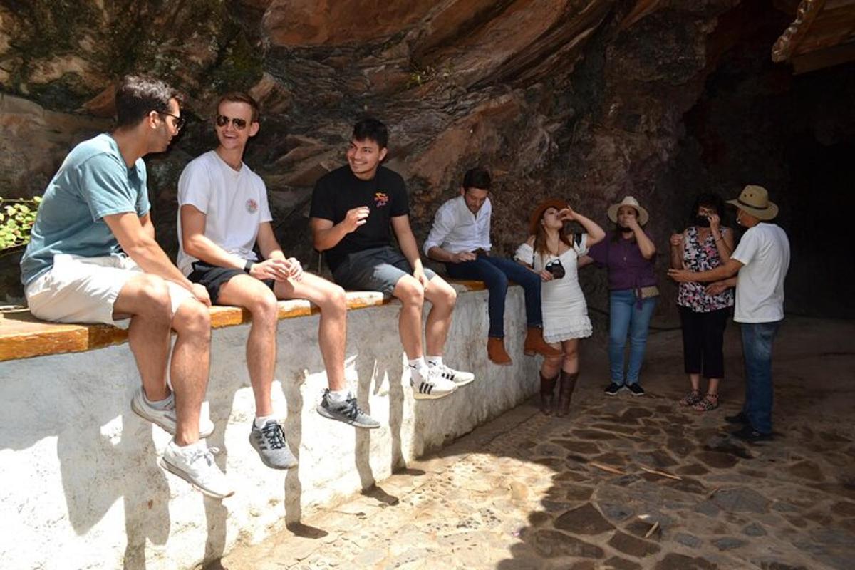 a group of people sitting on a bench in a cave