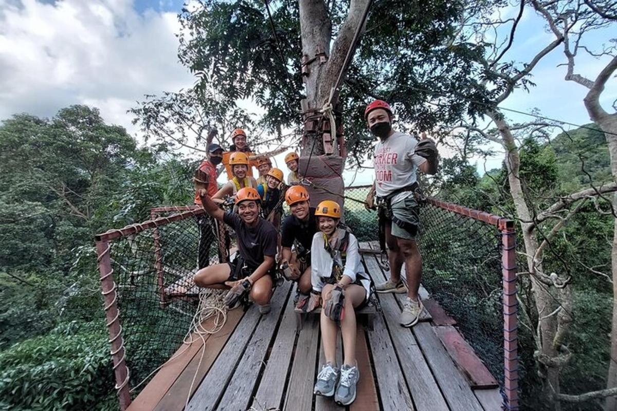 a group of people posing for a picture on a suspension bridge