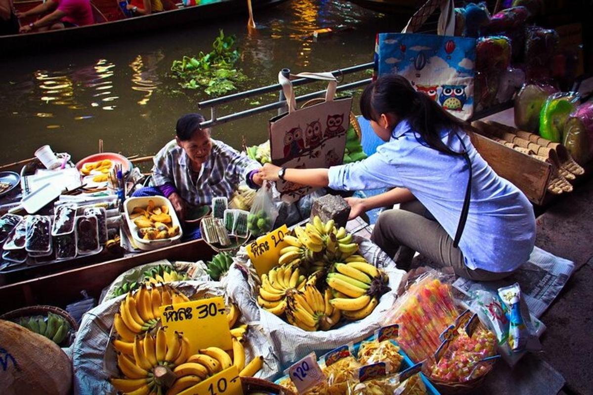 a man and a woman sitting in a market with bananas