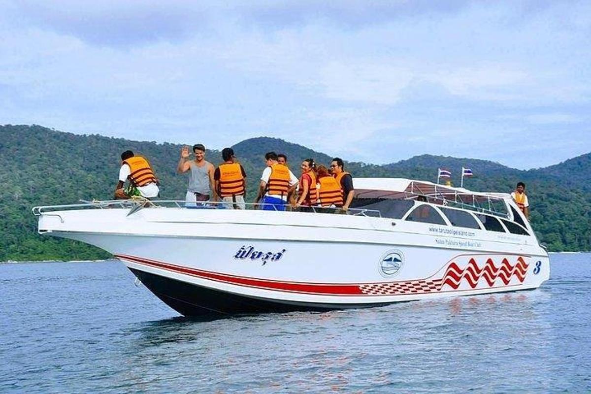 a group of people on a boat in the water