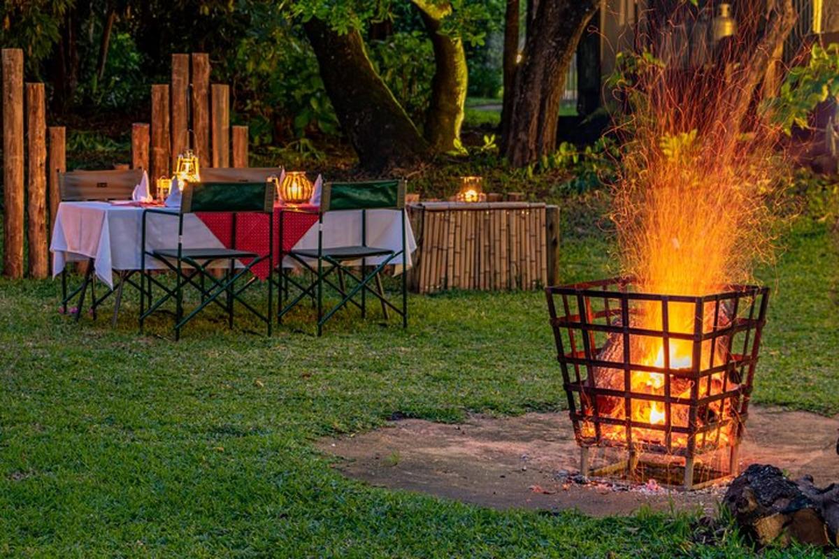 Una fogata con una mesa y sillas en un patio.