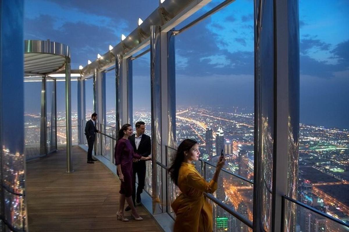 a group of people standing on the observation deck of a building