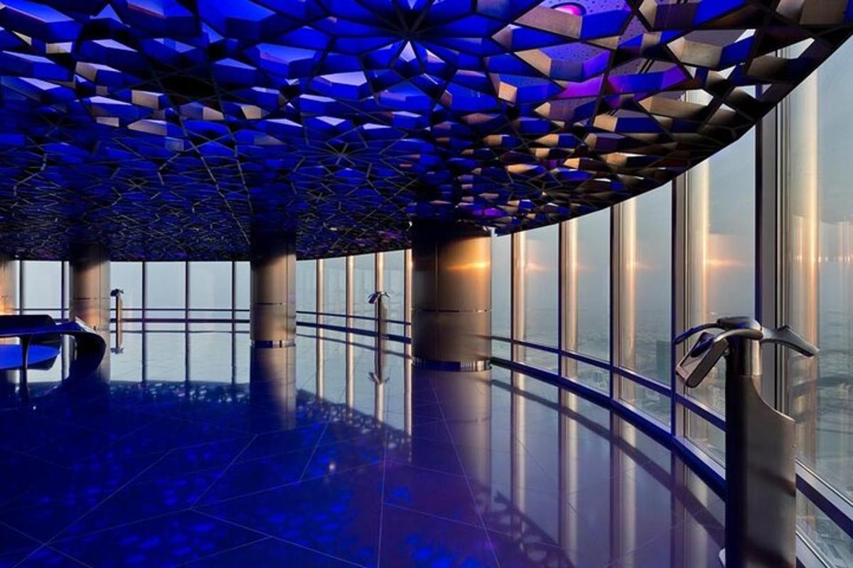 a swimming pool in a building with blue lights