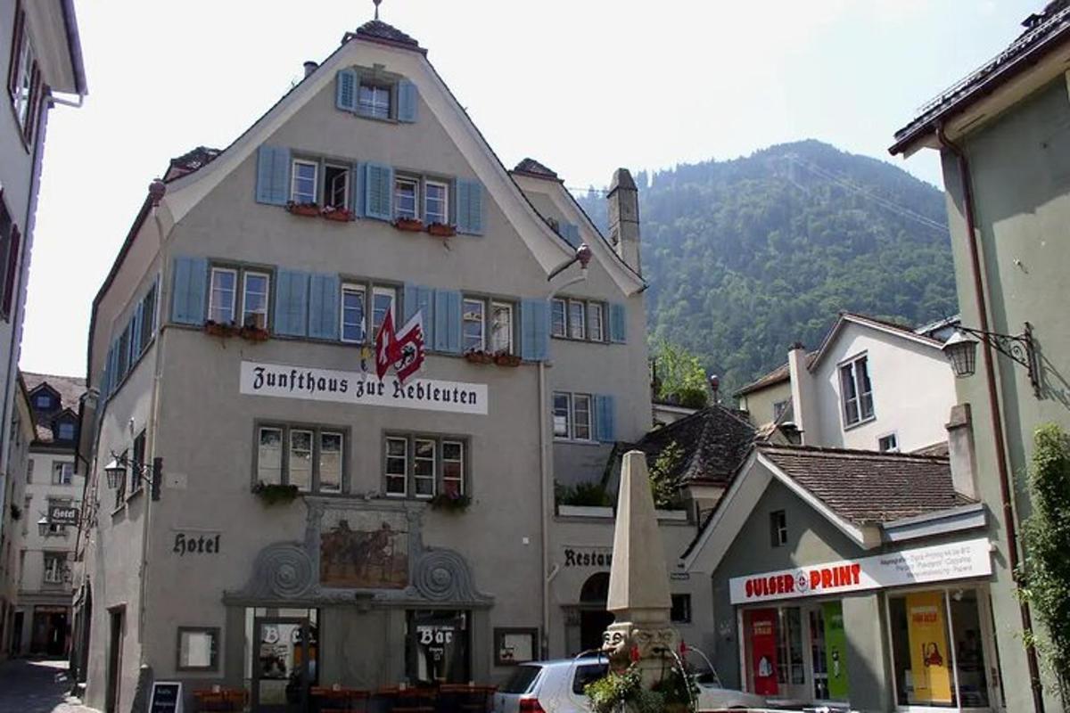 a building in a town with a mountain in the background