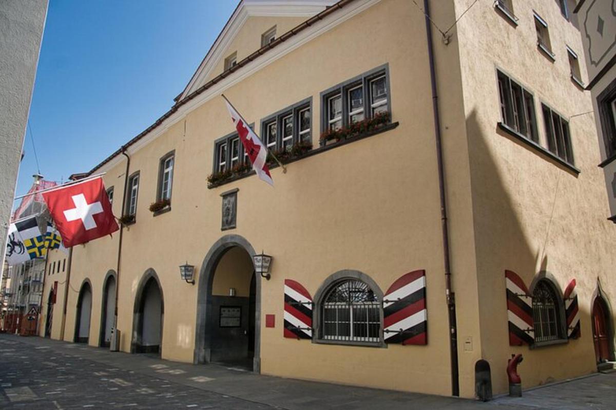 a building with flags on the side of a street