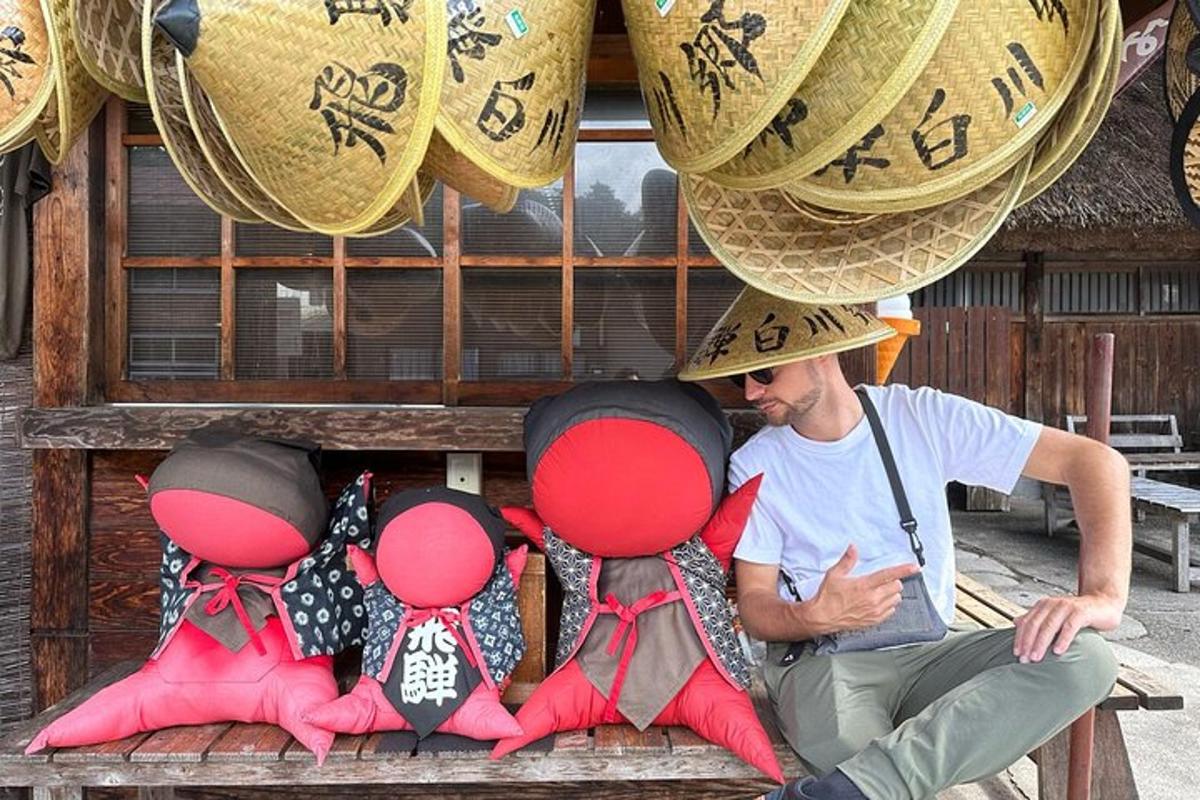 a man sitting on a bench with four dolls