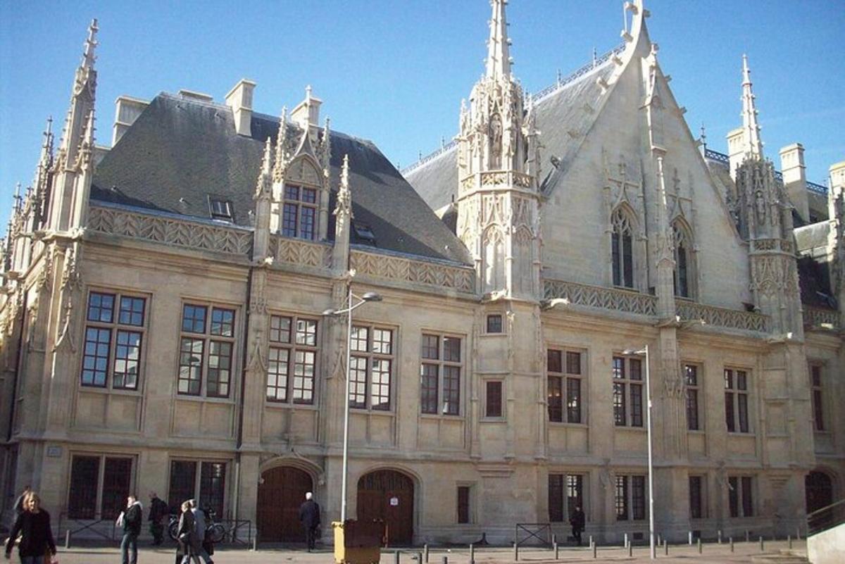 a large building with people walking in front of it