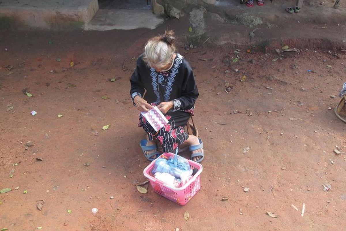 a woman sitting on a dirt ground with a basket
