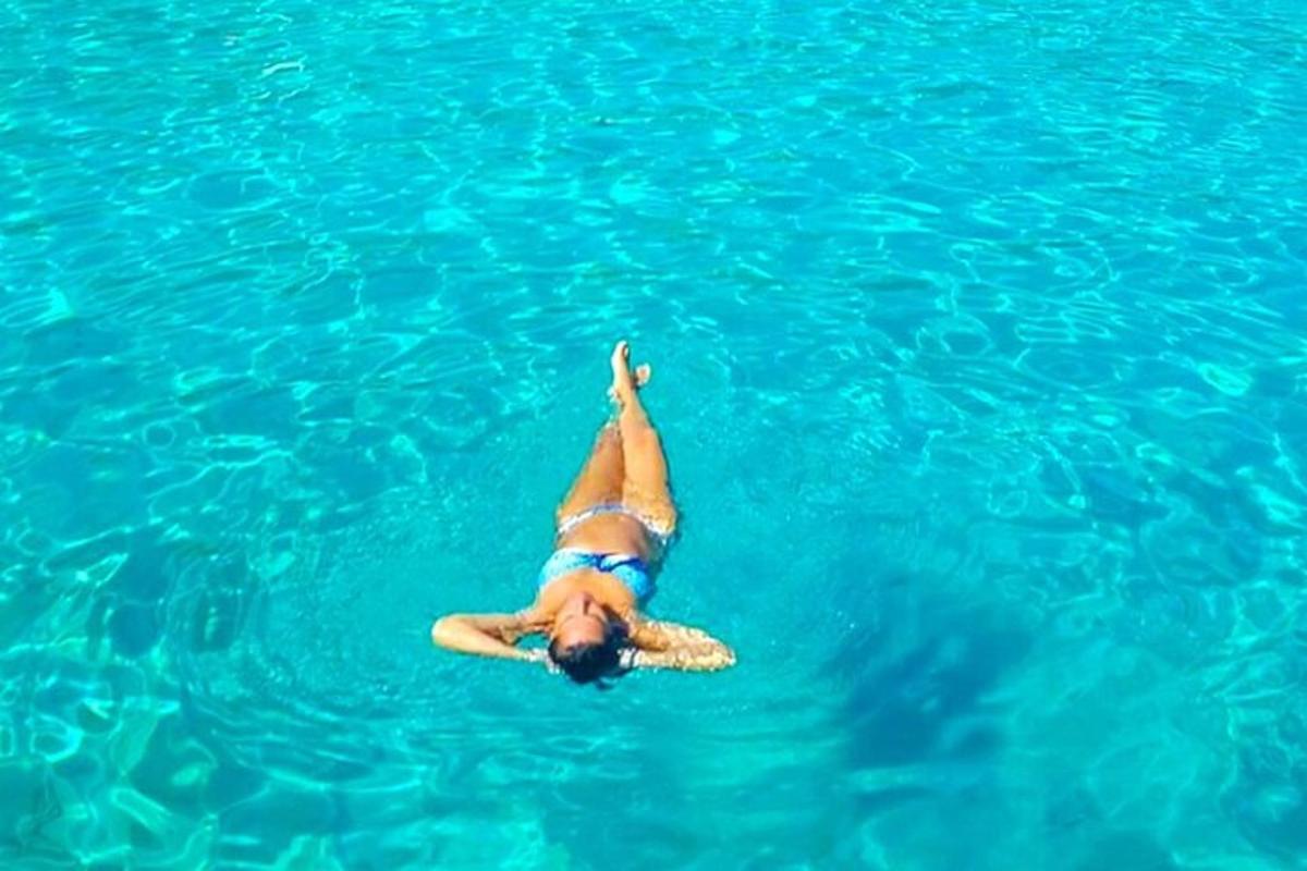 a woman laying on her back in the water