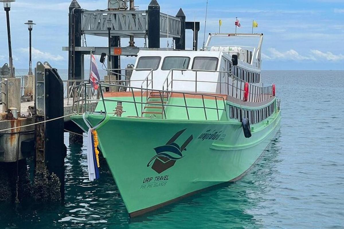 ein grün-weißes Boot an einem Dock
