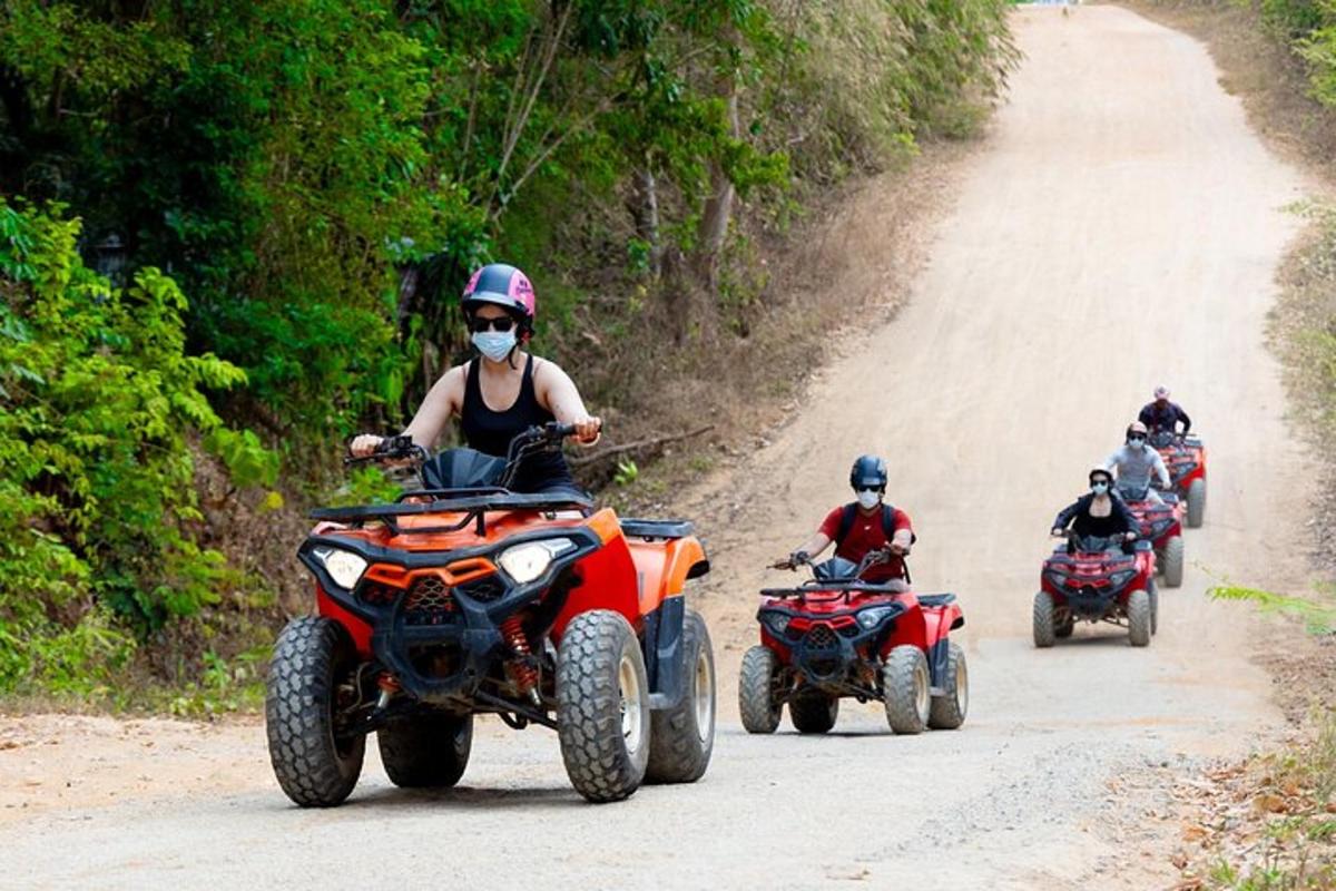 un gruppo di persone che guidano quad su una strada sterrata