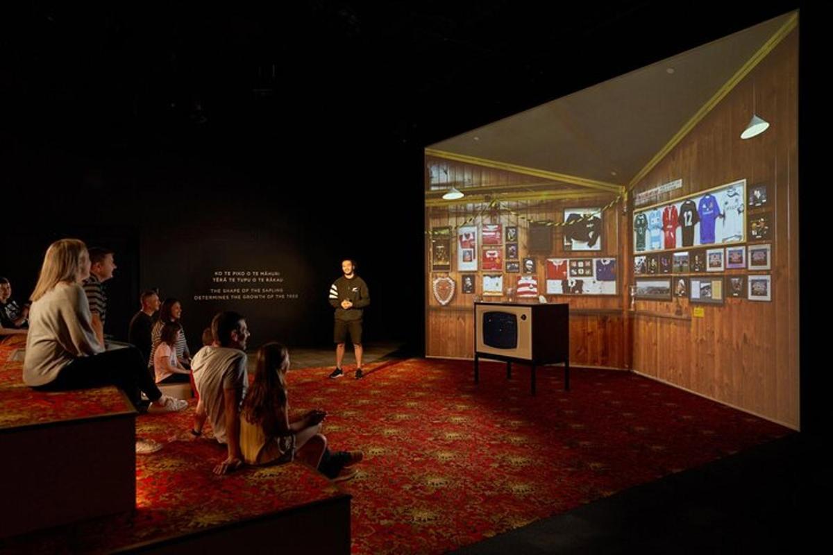 a man standing in front of a stage with a presentation