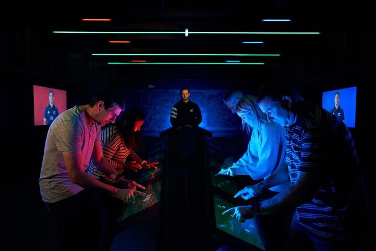 a group of people in a dark room playing a video game