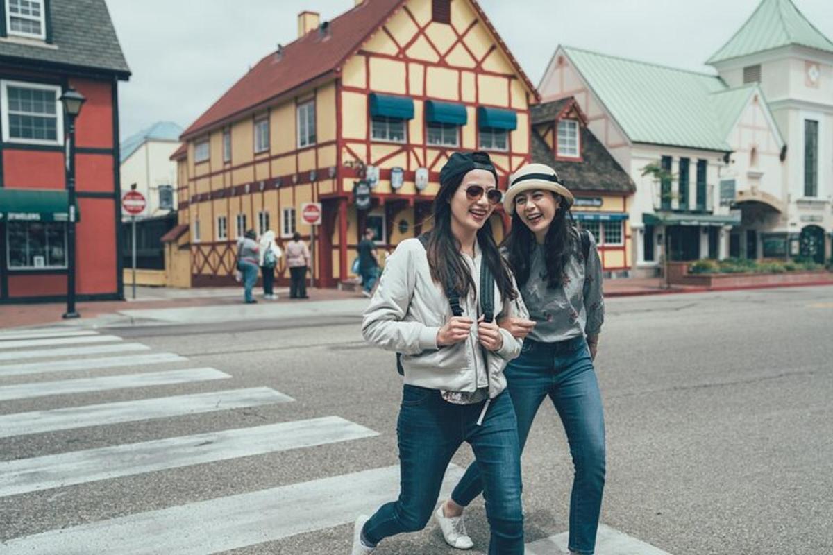 two women are crossing the street at a crosswalk