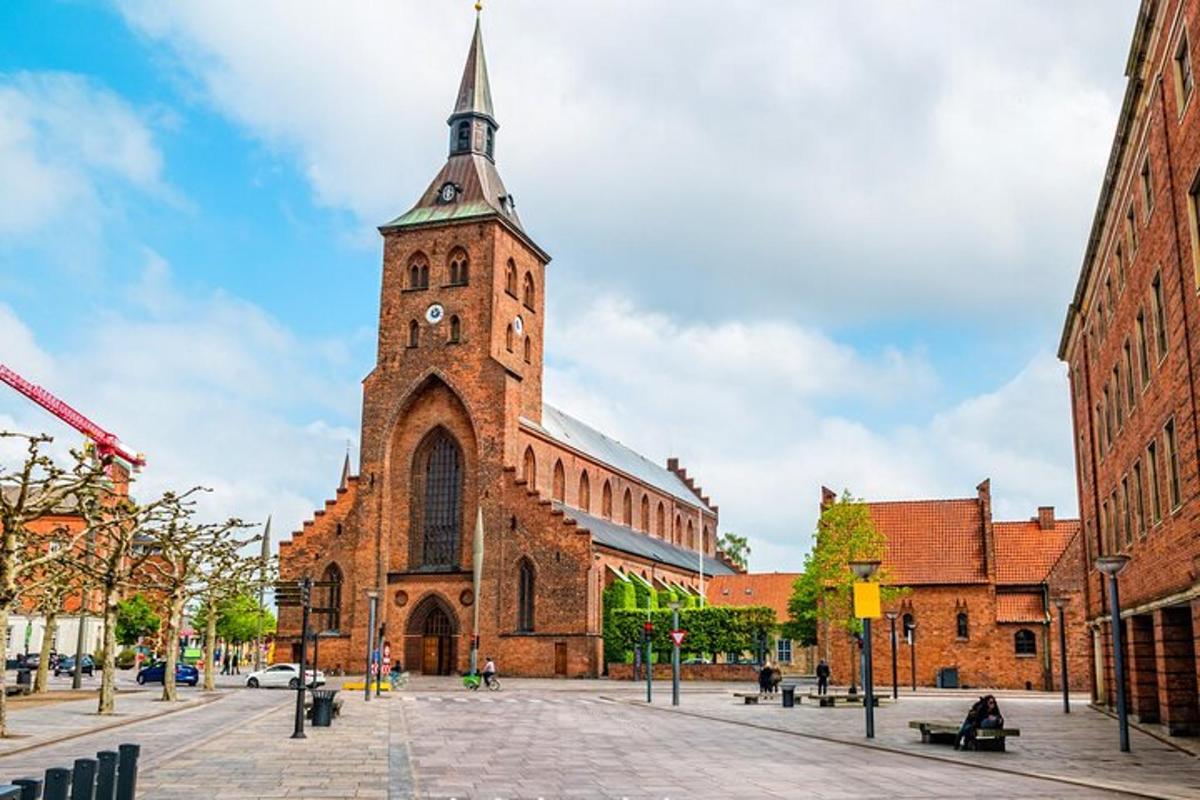 a large brick building with a clock tower on a street