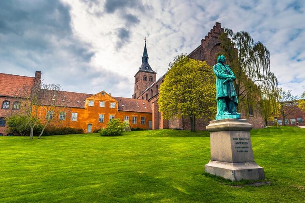 a statue in the grass in front of a building