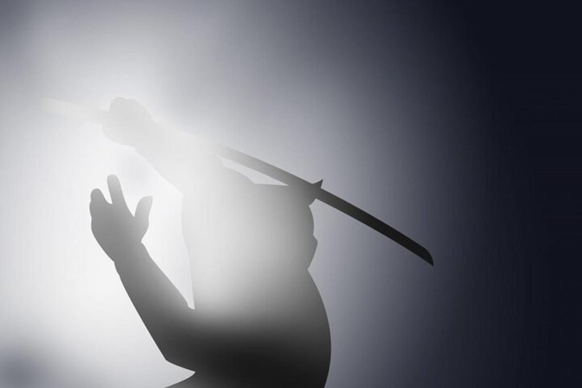 a silhouette of a person holding a knife