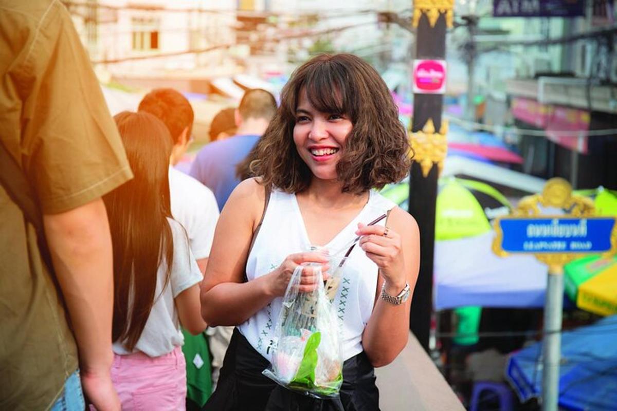 a woman is smiling while holding a bag of food