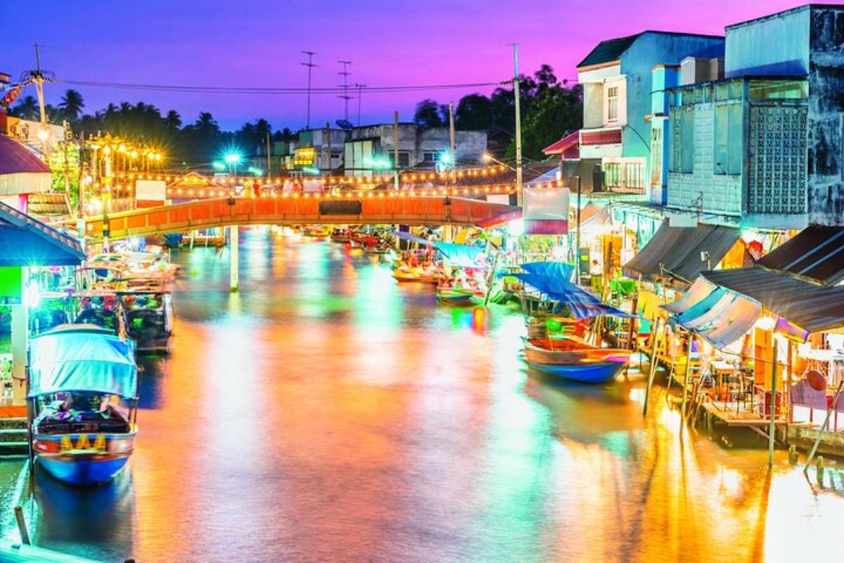 a group of boats docked in a river at night