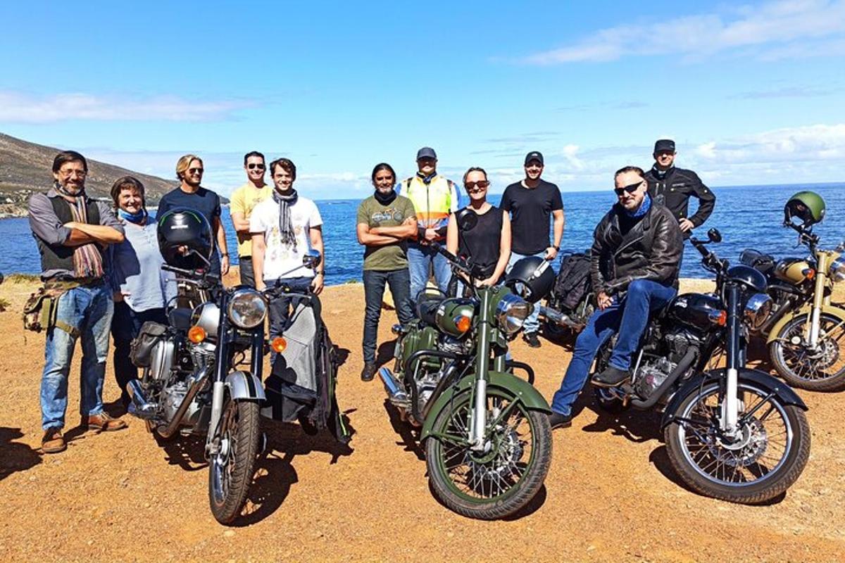 a group of people posing for a picture with their motorcycles