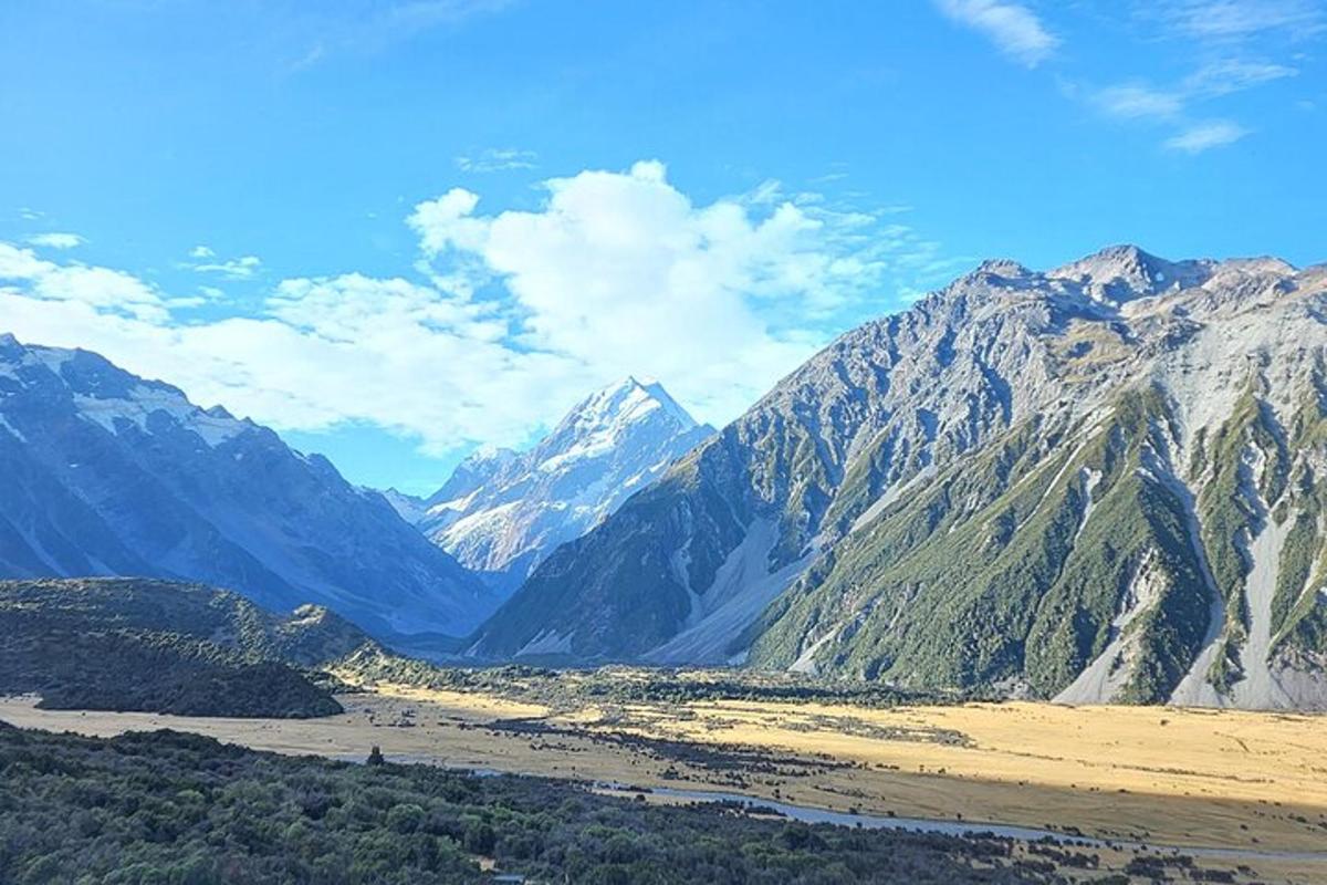 a view of a mountain range with snow capped mountains