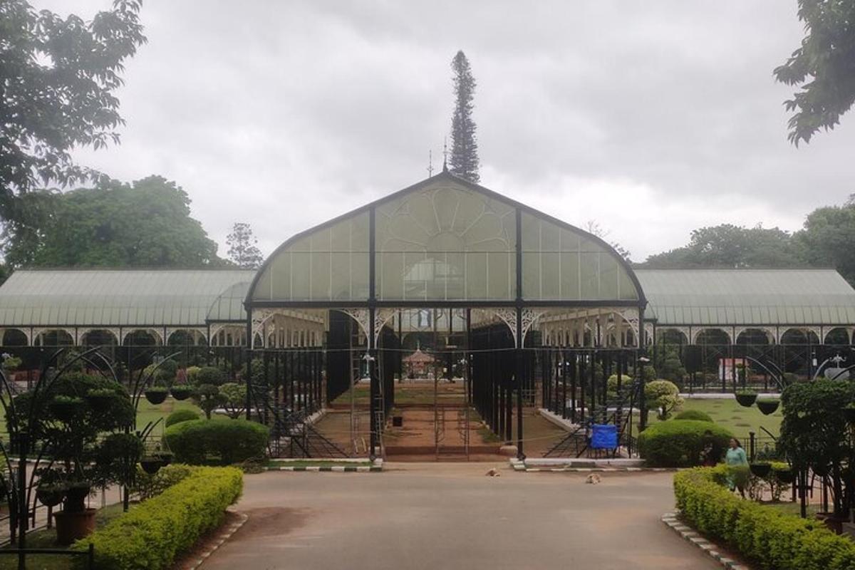 a large glass building with stairs in a park