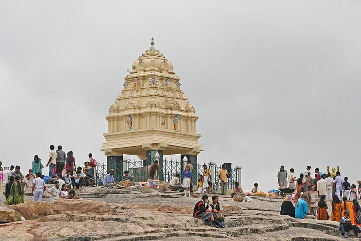 a group of people sitting around a building on the beach