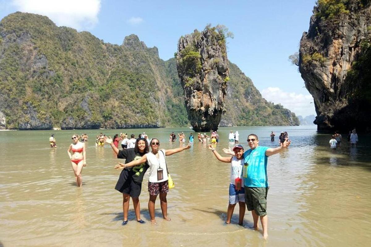 a group of people standing in the water at a beach