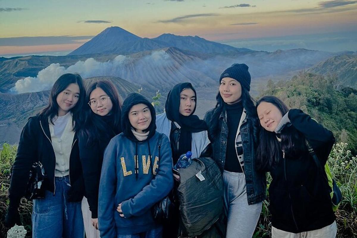 a group of women standing on top of a mountain